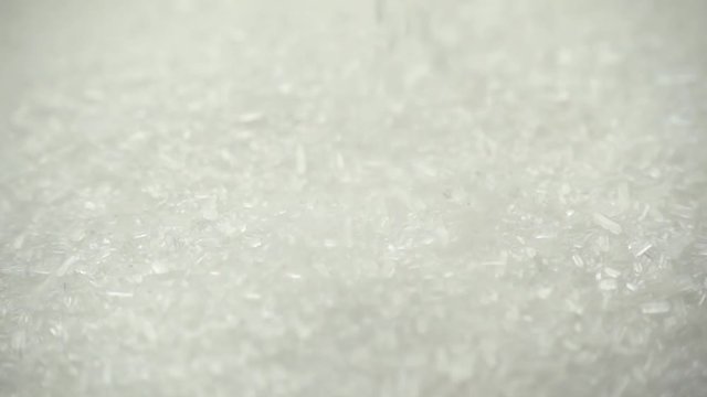 Close-up of monosodium glutamate falling in slow motion