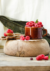 Fresh raspberry with basil in a cup of coffee and a wooden stand.Detox diet food concept.Selective focus.