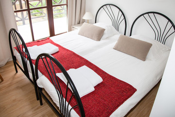 Double single Bed In The Bedroom With large windows