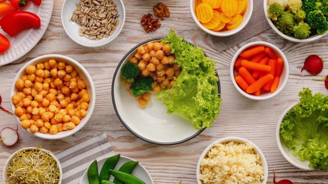 Buddha bowl, composition of various plant products, delicious and nutritious vegan food. Healthy eating concept. Stop motion animation, top view