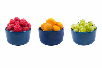 Berries on Isolated white background, bowl of gooseberries, raspberries, apricots