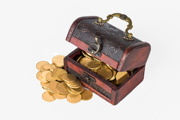 Pirate chest with scattered golden coins on a white background isolate