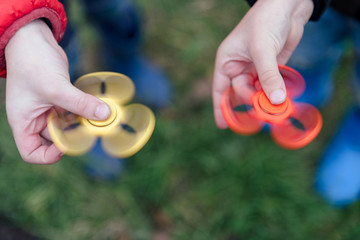 Young boy play with fidget spinner stress relieving toy
