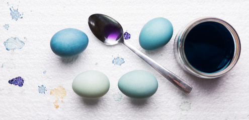 DIY dyed using red cabbage various shades of blue easter eggs drying on piece of polystyrene. DIY Happy Easter theme web banner.