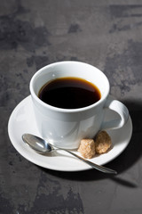 cup of black coffee on a dark background, vertical