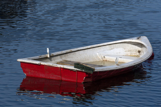 A Small Fiberglass Row Boat Slowly Sinking Into Loch Lomond