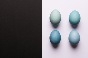 Happy Easter black and white background. Hand painted blue Easter eggs abstract minimal concept.
