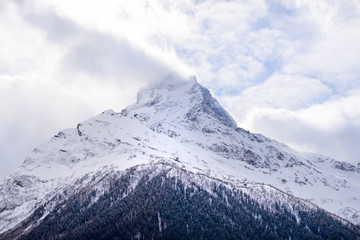Fototapeta na wymiar Snow peak of Caucasus in Dombai, Russia