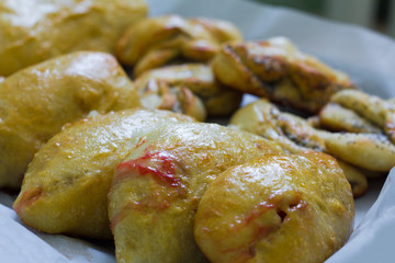 freshly baked homemade village cakes with viburnum and sweet buns with poppy seeds