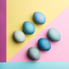 Happy Easter pastel coloured background. Hand painted Easter eggs abstract minimal concept.