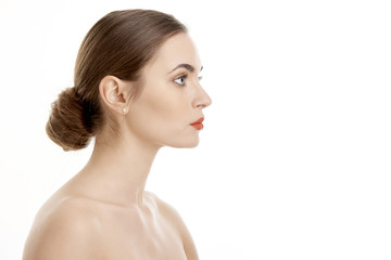 Close-up of beautiful young woman with red lips looking at camera while posing at isolated white background. Beauty shot in studio.