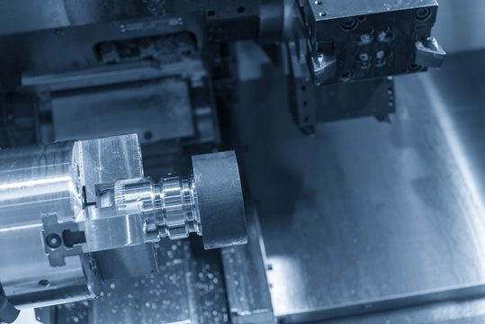 The CNC lathe machine cutting the metal rod .