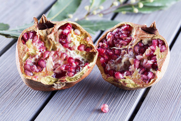 Pomegranate in halves over wooden table