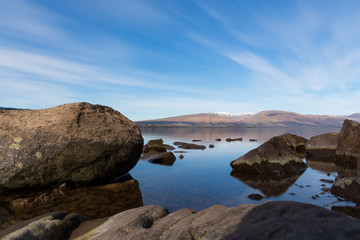 a low perspective view over the freshwater of Loch Lomond Scotland captured with a long exposure