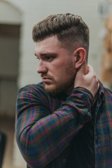 A man in a barber shop for haircuts and shaving