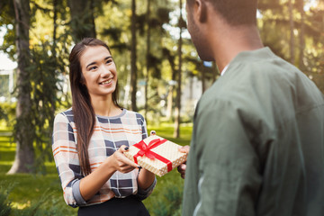 Man surprising his girlfriend with gift