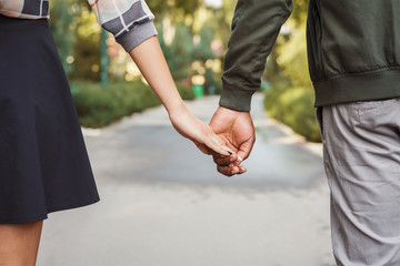 Multiethnic couple in love walk in park closeup