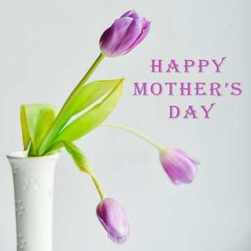 Floral Background, postcard: Tulip flower in white vase on white background. Layout, mocap, inscription: "Happy mothers day"