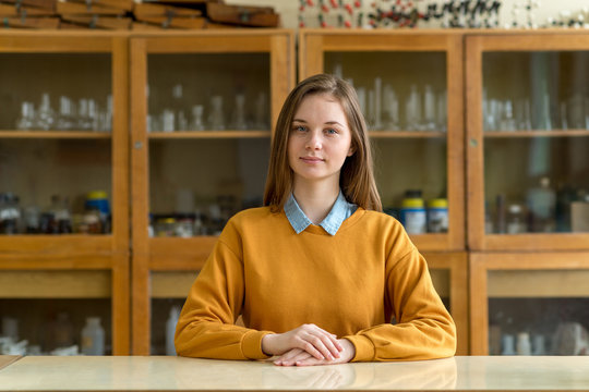 Portrait of young female college student in chemistry class. Focused student in classroom. Authentic Education concept.
