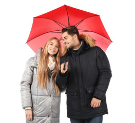 Young romantic couple with bright umbrella on white background