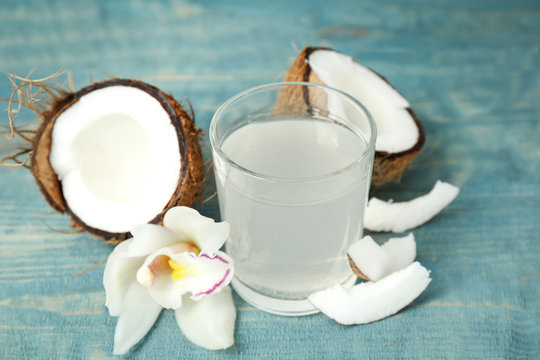 Glass Of Coconut Water On Wooden Table