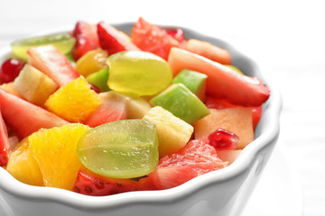 Fototapeta na wymiar Bowl with fresh cut fruits, closeup