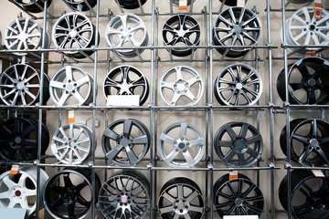 Alloy wheels on racks in automobile service center