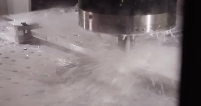 Close-up of a water jet metal cutting machine in slow motion