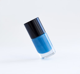 Blue nail polish bottle on whitw background
