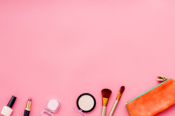 Beauty set with decorative cosmetics. nail polish, brushes and bag on pink background top view mockup