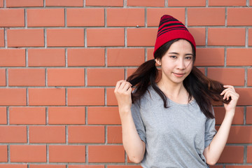 Portrait asian hipster girls on brick wall background,Hippie dress style,Thailand modern woman lifestyle,Beauty fashion portrait outdoor