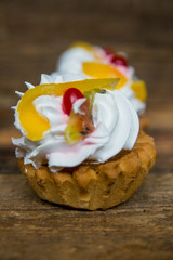 a set of pastries: cream puffs and fresh fruit