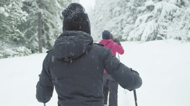 Three young ladies hiking together on a snowy day