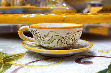 Close-up of a cup and saucer with a beautiful pattern on the table