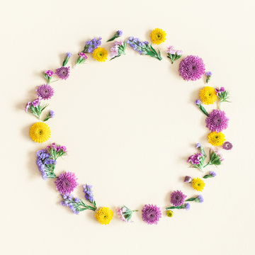 Flowers composition. Wreath made of colorful flowers on pastel yellow background. Flat lay, top view, square, copy space