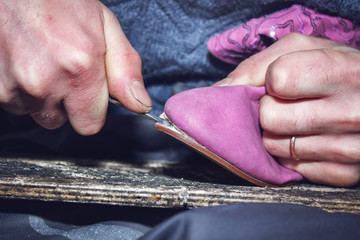 Shoemaker repairing a shoes