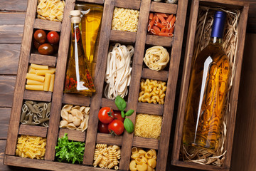 Various pasta in wooden box and wine