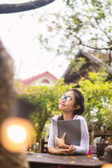 Asian women writing diary in notebook.