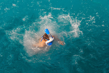 Boy swim in the ocean with snorkeling mask. Summer background