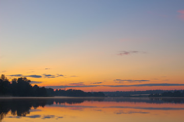 Fototapeta na wymiar beautiful landscape of the lake at sunset. blue sky and orange glow.