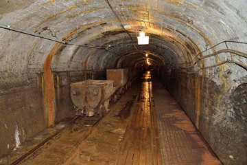 Fototapeta na wymiar Mining - A Oil shale mining tunnel with tram lines
