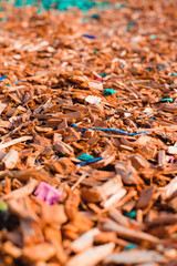 Textured background decorative colored sawdust for finishing flowerbeds in the winter season in outlook. orange, yellow sawdust