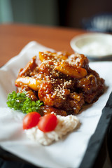 Close-up view of some delicious fried chicken coated with sweet and spicy sauce