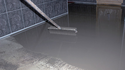 Floor leveling. Filling the floor with a self-leveling compound