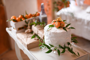 Gender reveal cake on baby shower party with box of mandarins