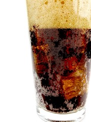 Cola with ice cubes in a clear glass against a white background