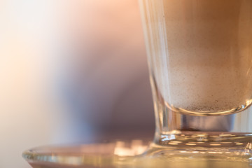 Close up of glass cup of hot coffee latte.