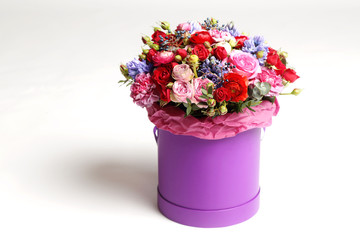 Beautiful bouquet of different flowers in a hat box.