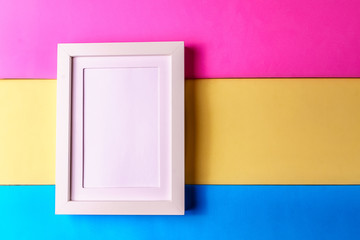 Abstract minimalism colofrul paper background with empty picture frame.