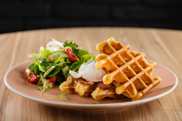 Savory Belgian waffles with egg poached, bacon and salad © torriphoto